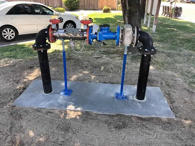 Irrigation backflow assembly mounted above grade on a residential service